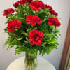 Red Carnations beautifully arranged in a vase