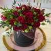 A timeless mini floral arrangement featuring fresh red mini roses, designed in