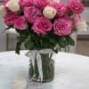 An elegant floral arrangement presented in a clear glass base, enhancing the