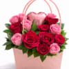 A stunning blend of velvety red and soft blush pink roses arranged