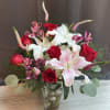 A passionate allure of red roses intertwines with the delicate charm of