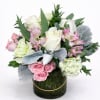 A soft and romantic mix of premium roses, seasonal blooms, and lush