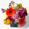 Vibrant blossoms of that day roses orchids and more arranged in a