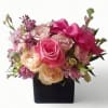 Roses orchids and more arranged in a black modern glass cube style