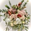 A stunning arrangement of premium roses, protea, callas, hydrangea, and/or varietals of