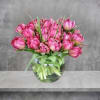 A bunch of wonderful tulips all in a round vase. 