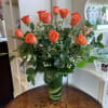 Premium longstem orange roses arranged with complimenting filler flower and greens in