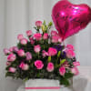 A medium size arrangement with pink roses and green decoration in the