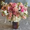 A beautiful non traditional  arrangement in soft pinks and creams. 