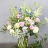 A gathering of soft-hued flowers in a grand design inspired by the