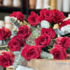 The standard size bouquet includes one dozen premium red roses with fillers