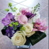 small cube arrangement with roses, orchids, mini callas, and stocks