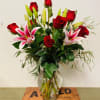 One dozen long- stemmed Ecuadorian roses with Oriental lilies, expertly arranged in