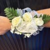 This white wrist corsage blends delicate textures and clean design, creating a