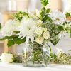 White Snapdragon, Lilies, Daisies, Spray Roses and chrysanthemums arranged in a cinch