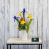 Tulips, iris and daffodils fill a classic glass vase!  The epitome