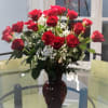 24 Long stem roses in a clear vase (Ruby vase is SOLD