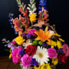 A beautiful mix of fresh flowers with popping colors and accented with
