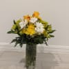 A radiant and cheerful arrangement featuring vibrant yellow roses with delicate orange