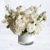 Monochrome Garden is a layered all-white composition featuring ranunculus, hydrangea, lisianthus, and
