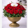 A lush, classic arrangement of fresh red roses topped with a white
