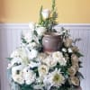 A classic arrangement featuring whites and greens reflects a spirit of peace