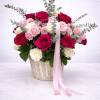 A luxurious floral basket brimming with deep fuchsia roses, creamy ivory roses