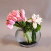 Minimalist, classic, chic. This simple vase arrangement showcases a cluster of Tulips
