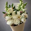 A refined, garden-inspired wrapped bouquet designed in a soft palette of creamy