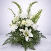 An elegant all-white arrangement featuring fresh roses, lilies, snapdragons, carnations, and lush