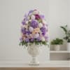 A sculptural Easter centerpiece blooming in soft lavender, blush, and cream. Designed