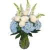 Snapdragons,  hydrangeas, roses and other blooms are in this beautiful arrangement.