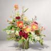 A sunlit celebration of color and texture, this arrangement bursts with vitality.