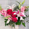 Snap dragons, oriental lilies, and roses.   A beautiful combination designed