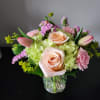 Hydrangea, tulips, roses, statice, carnations, and a mixture of greenery arranged in
