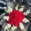 This bouquet has fresh red roses and white stock flower rim