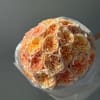Bouquet of peach and cream roses wrapped in white paper