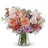 Peach Roses, alstroemeria,  pom pon mums and more in a clear