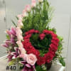 1 dozen light pink rose, 15 red carnations in a shape of