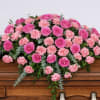 Delicate mix of pink roses and pink carnations with lush greens designed
