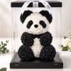 A charming panda bear handcrafted from black and white rose florals, beautifully