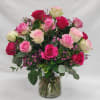 24 medium stem roses of mixed pink colors in a vase with
