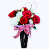 "A striking arrangement of rich red roses paired with delicate baby&rsquo;s breath.
Presented