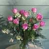 We will arrange a dozen premium pink or lavender roses with fillers