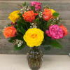 This classic arrangement features 12 mixed colored roses with premium greens and