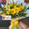 A cheerful hand-tied bouquet featuring a radiant mix of yellow blooms, including