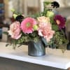 A smattering of cute blooms in a mini vase! Let us pick