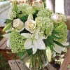 Transform any space with this bouquet featuring white roses, lush green hydrangeas