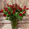 Beautiful long-stemmed red roses presented in a high quality clear glass or