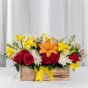 A vibrant mix of red roses, orange and yellow lilies, white blooms